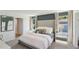 A serene primary bedroom with a tufted headboard, neutral tones, and ample natural light at 10492 Tucker Rd, Weeki Wachee, FL 34613