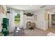 Bright office space with a gray carpet, white walls, natural light, desk, and playful decor at 10492 Tucker Rd, Weeki Wachee, FL 34613