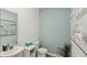 Cozy powder room featuring a modern sink, toilet, and stylish decor with calming paint tones at 10492 Tucker Rd, Weeki Wachee, FL 34613