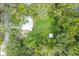 Aerial view of a home surrounded by lush trees and green space at 304 Highland St, Brooksville, FL 34601