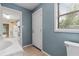 The powder room connects to the kitchen and features tiled floors and a window at 304 Highland St, Brooksville, FL 34601
