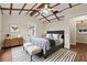 Charming bedroom featuring a neutral palette, vaulted ceiling, and decorative rug at 304 Highland St, Brooksville, FL 34601