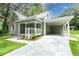 Charming one-story home with a covered parking area and well-maintained landscaping at 304 Highland St, Brooksville, FL 34601