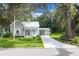 Charming one-story home with a cozy front porch and beautiful landscaping at 304 Highland St, Brooksville, FL 34601