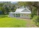Exterior view of home with lush, green lawn at 304 Highland St, Brooksville, FL 34601