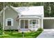 Charming one-story home with a cozy front porch and beautiful landscaping at 304 Highland St, Brooksville, FL 34601