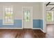 The inviting living area features gleaming hardwood floors and a decorative stained-glass front door at 304 Highland St, Brooksville, FL 34601