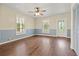 The living room boasts hardwood floors, a ceiling fan, and classic trim, exuding timeless charm at 304 Highland St, Brooksville, FL 34601