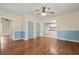 View of the light-filled living room, flowing into the kitchen with matching blue trim at 304 Highland St, Brooksville, FL 34601