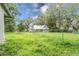 Spacious yard with green grass and mature trees at 304 Highland St, Brooksville, FL 34601