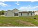 Exterior view of home showcasing siding, patio, and backyard at 14150 Prospect St, Spring Hill, FL 34609