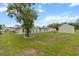 Large backyard featuring the home and shed at 14150 Prospect St, Spring Hill, FL 34609