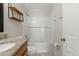 Charming bathroom with granite countertop, wood cabinets, and white tiled bath/shower at 14150 Prospect St, Spring Hill, FL 34609