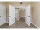 This vacant bedroom offers plank flooring and leads to an ensuite bathroom at 14150 Prospect St, Spring Hill, FL 34609