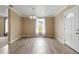 Inviting dining room with wood floors, ample natural light, and a modern chandelier at 14150 Prospect St, Spring Hill, FL 34609