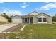 Charming single-story home with green siding, a well-manicured lawn, and an attached two-car garage at 14150 Prospect St, Spring Hill, FL 34609