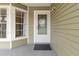 Inviting front entrance featuring a glass door, large window, and neutral siding at 14150 Prospect St, Spring Hill, FL 34609
