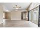 Open living space with wood floors, vaulted ceilings, and access to the patio at 14150 Prospect St, Spring Hill, FL 34609