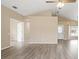 Open-concept living area with wood floors, vaulted ceilings, and plenty of natural light at 14150 Prospect St, Spring Hill, FL 34609