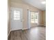 Bright living room with wood floors, large windows, and fresh neutral paint at 14150 Prospect St, Spring Hill, FL 34609
