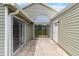 View of the covered patio with siding and large windows at 14150 Prospect St, Spring Hill, FL 34609