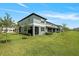 Exterior of a two-story home with a well-maintained lawn, patio and landscaping at 14347 Easy Goer St, Ruskin, FL 33573