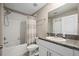 Clean bathroom with a shower/tub combo, granite counters, and modern fixtures in a neutral color scheme at 14347 Easy Goer St, Ruskin, FL 33573