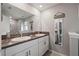 Upstairs bathroom with a double sink vanity, granite countertops, and a large, framed mirror at 14347 Easy Goer St, Ruskin, FL 33573
