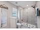 Bathroom featuring tiled shower, toilet, and window for ventilation and natural light at 14347 Easy Goer St, Ruskin, FL 33573