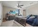 Spacious bedroom featuring carpet, a ceiling fan, television, and an en-suite bathroom at 14347 Easy Goer St, Ruskin, FL 33573