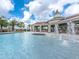 Stunning community pool featuring a splash fountain, covered seating, and lounge chairs, perfect for relaxation at 14347 Easy Goer St, Ruskin, FL 33573