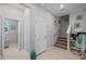 Upstairs hallway with neutral paint, carpeted stairs, access to the bathroom, and an open office area at 14347 Easy Goer St, Ruskin, FL 33573
