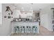Inviting kitchen featuring white cabinetry, granite counters, stainless appliances, and barstool seating at 14347 Easy Goer St, Ruskin, FL 33573