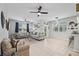 Spacious living room featuring neutral colors, tile floors, and seamless flow to the kitchen at 14347 Easy Goer St, Ruskin, FL 33573