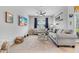 Cozy living room with tile flooring, neutral decor, comfortable seating, and a ceiling fan at 14347 Easy Goer St, Ruskin, FL 33573
