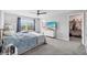 Bright main bedroom featuring a walk-in closet, plush carpet, and an en-suite bathroom at 14347 Easy Goer St, Ruskin, FL 33573