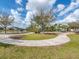 Neighborhood playground with winding sidewalks, lush grass, and a picturesque lake view, great for to play at 14347 Easy Goer St, Ruskin, FL 33573