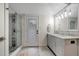 Bathroom featuring double vanity, glass enclosed shower, and outdoor access at 2715 14Th N Ave, St Petersburg, FL 33713