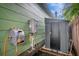 View of the exterior shows a modern tankless water heater, shed and mounted hose reel at 2715 14Th N Ave, St Petersburg, FL 33713