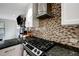Updated kitchen featuring granite counters, stainless hood and mosaic tile backsplash at 2715 14Th N Ave, St Petersburg, FL 33713