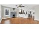 Bright living room featuring hardwood floors and a fireplace that opens into a modern kitchen at 2715 14Th N Ave, St Petersburg, FL 33713