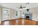 Cozy living room with hardwood floors, a brick fireplace, and plenty of natural light at 2715 14Th N Ave, St Petersburg, FL 33713