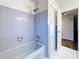 Bathroom with a shower-tub combination and ceramic tile with a bright white-painted door frame at 1137 Indian Rocks S Rd, Largo, FL 33770