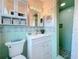 Charming bathroom with vintage green and turquoise tiling, white vanity, and a walk-in shower at 1137 Indian Rocks S Rd, Largo, FL 33770