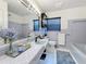 Updated bathroom with a large mirror, tiled countertop, and modern fixtures at 1137 Indian Rocks S Rd, Largo, FL 33770