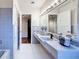 Bathroom featuring tile countertop, large mirror, vanity, and shower at 1137 Indian Rocks S Rd, Largo, FL 33770