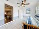 Bright bedroom features tile flooring, a ceiling fan, and closet with mirrored doors at 1137 Indian Rocks S Rd, Largo, FL 33770