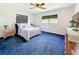 Bright bedroom with blue carpet, neutral walls, and a window bringing in lots of natural light at 1137 Indian Rocks S Rd, Largo, FL 33770