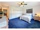 Light bedroom with blue carpet, white walls, and a window with dark wooden blinds at 1137 Indian Rocks S Rd, Largo, FL 33770