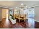 Cozy dining room featuring hardwood floors, modern decor, and a sliding barn door to the bedroom at 1137 Indian Rocks S Rd, Largo, FL 33770
